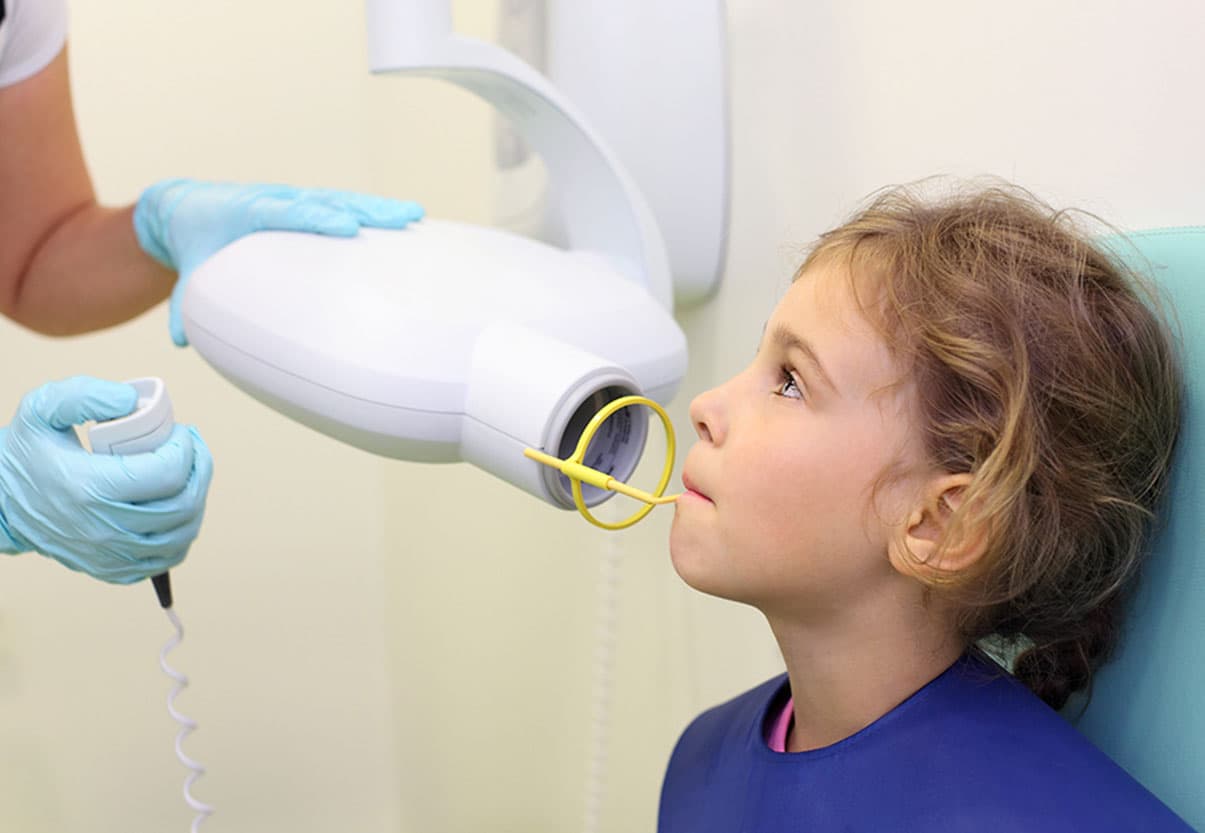 A child recives a dental x-ray at the dentist